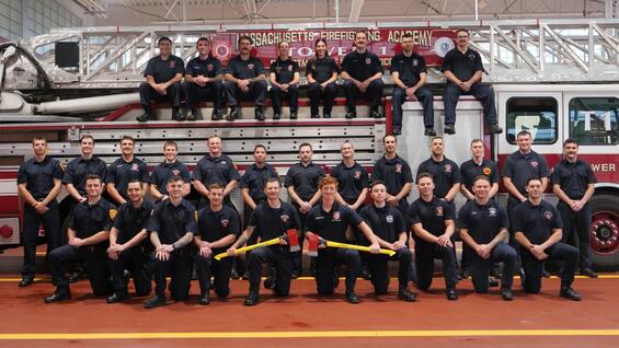 New firefighters on and around a ladder truck