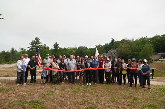 Partners hold a ribbon to cut to celebrate the project's completion.