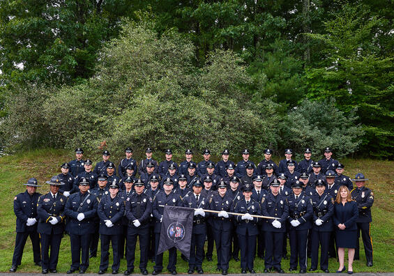 Police Officers pose for a graduation photo outdoors
