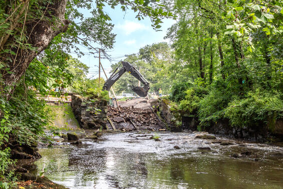 A construction vehicle works on removing the dam