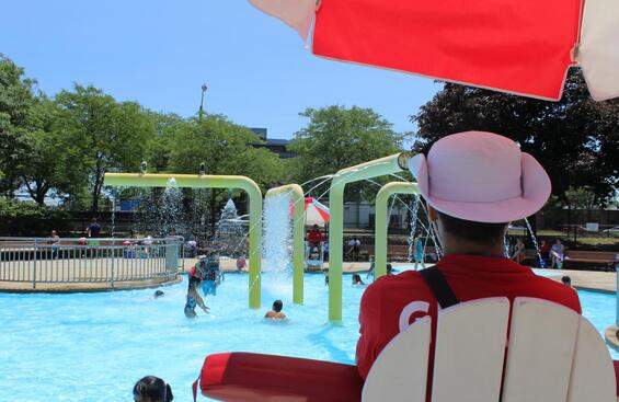 A lifeguard watches over children playing in a pool