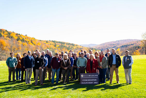 A group of people with a mountain in the background.