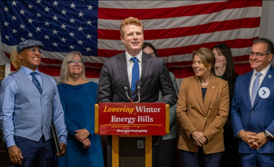 Joe Kennedy III stands at a podium with Governor Healey and other people