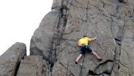 Man rock climbing on cliffside.
