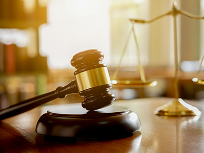 A gavel and scales on a desk.