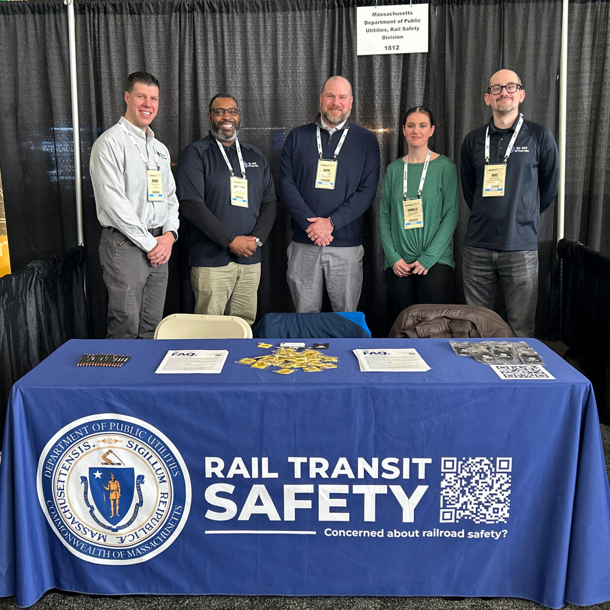 DPU staff stand behind the Rail Transit Safety table at the MMA trade show