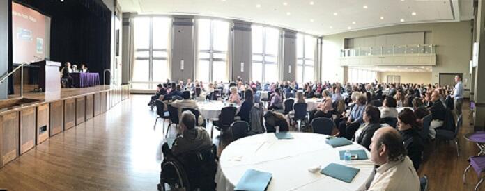 Ballroom with many people sitting at tables