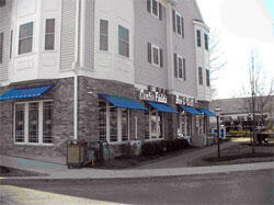 Ground floor retail with housing above, across from station