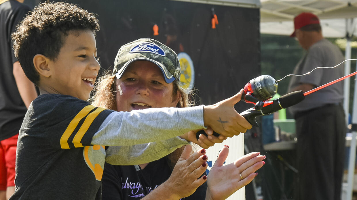 Kid fishing with instructor