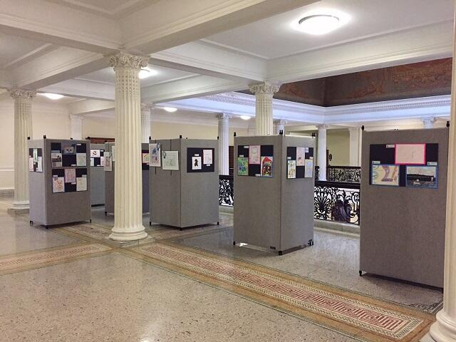 View of artwork on display boards in fourth floor gallery area