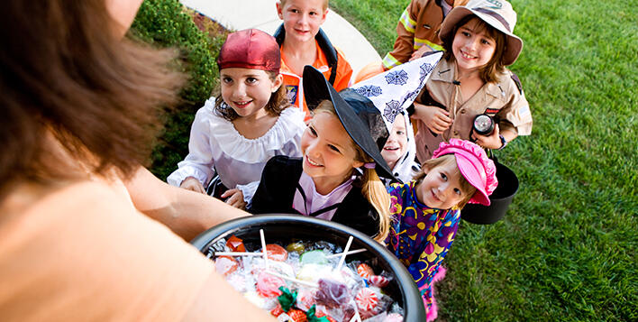 Children trick-or-treating in Halloween costumes