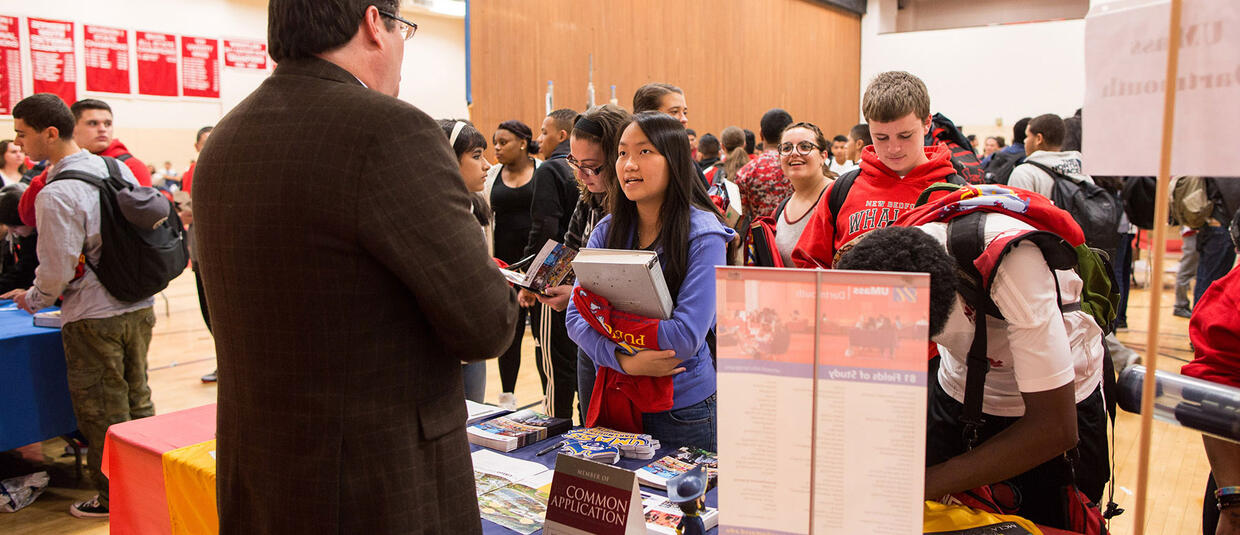 Students at New Bedford High School talk to admissions counselors at Go Higher fair.