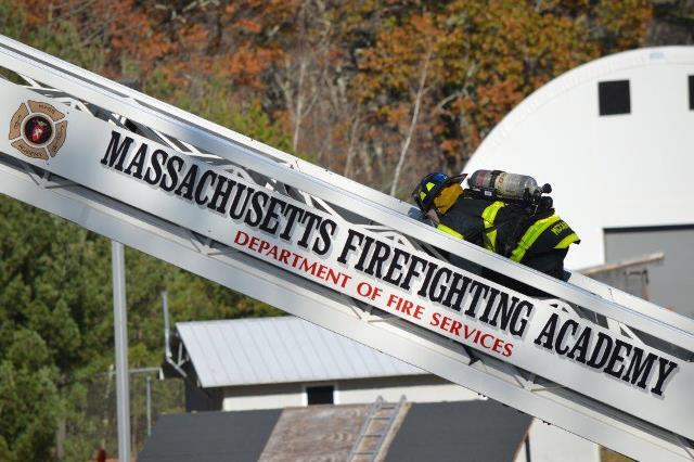 Recruit firefighter on a ladder at Mass. Firefighting Academy