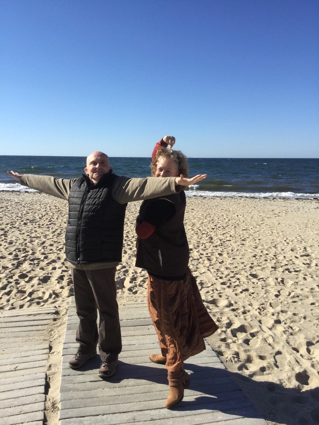 Glenn and Cheryl dance at the beach on a sunny day