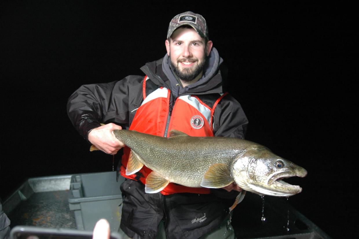 MassWildlife biologist holding lake trout