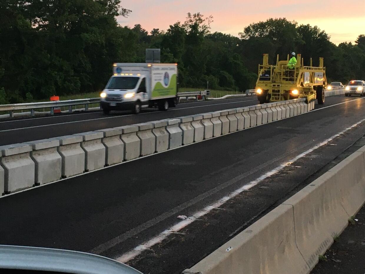 Crews installing the movable median barrier of the crossover on I-90.