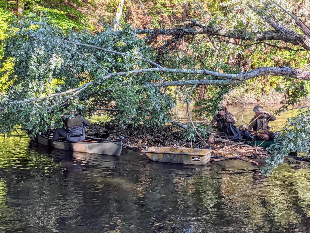 BHA volunteers clean up trash by boat