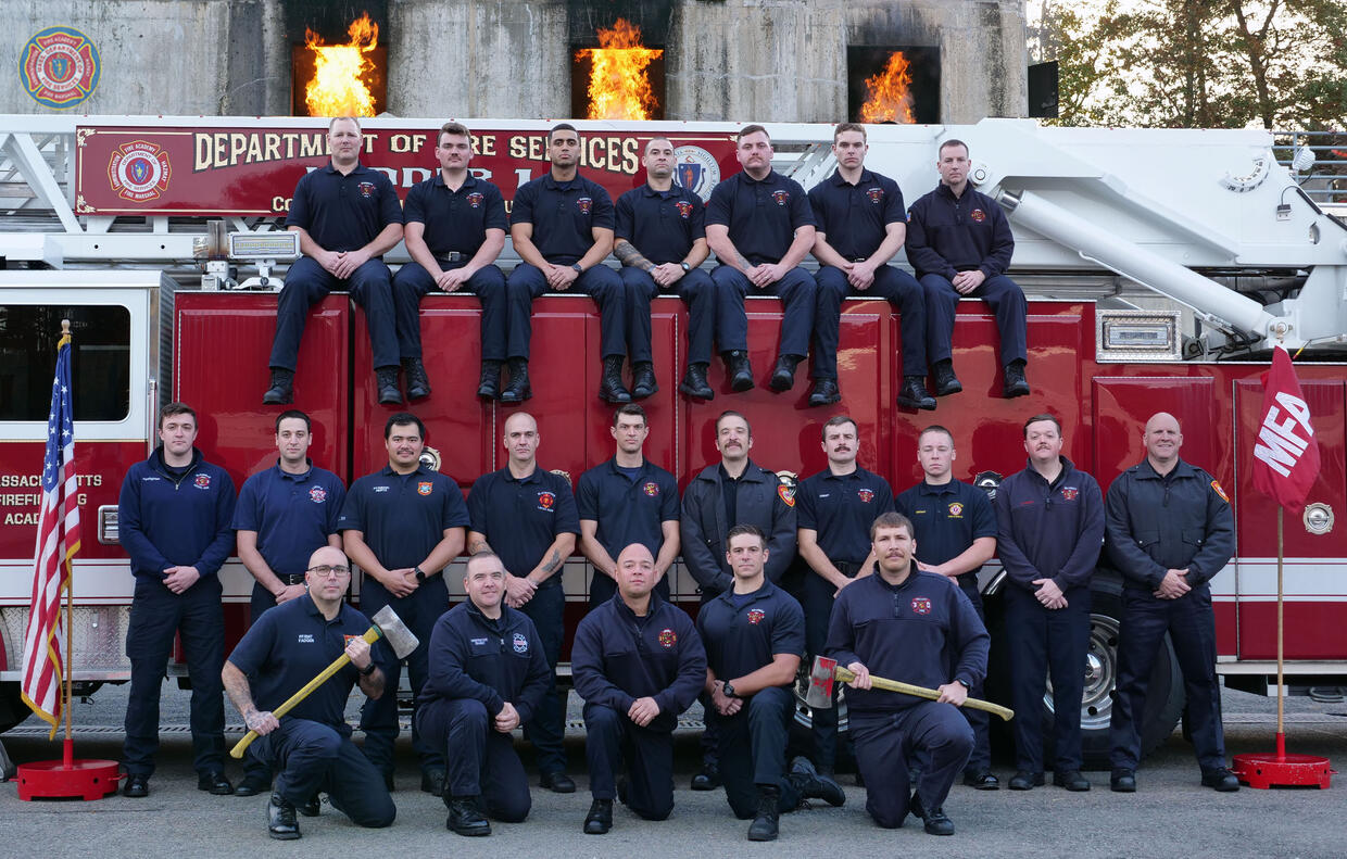 22 firefighters on and around a ladder truck