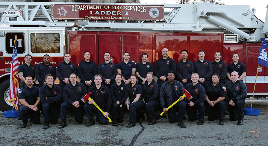 23 firefighters on and around a ladder truck