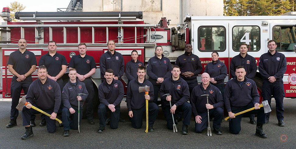 17 firefighters on and around a ladder truck