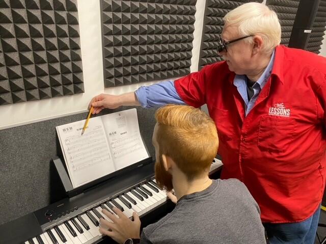 Claude teaching a student a piano lesson