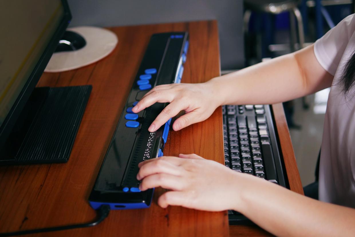 Image of woman using keyboard for visually impaired