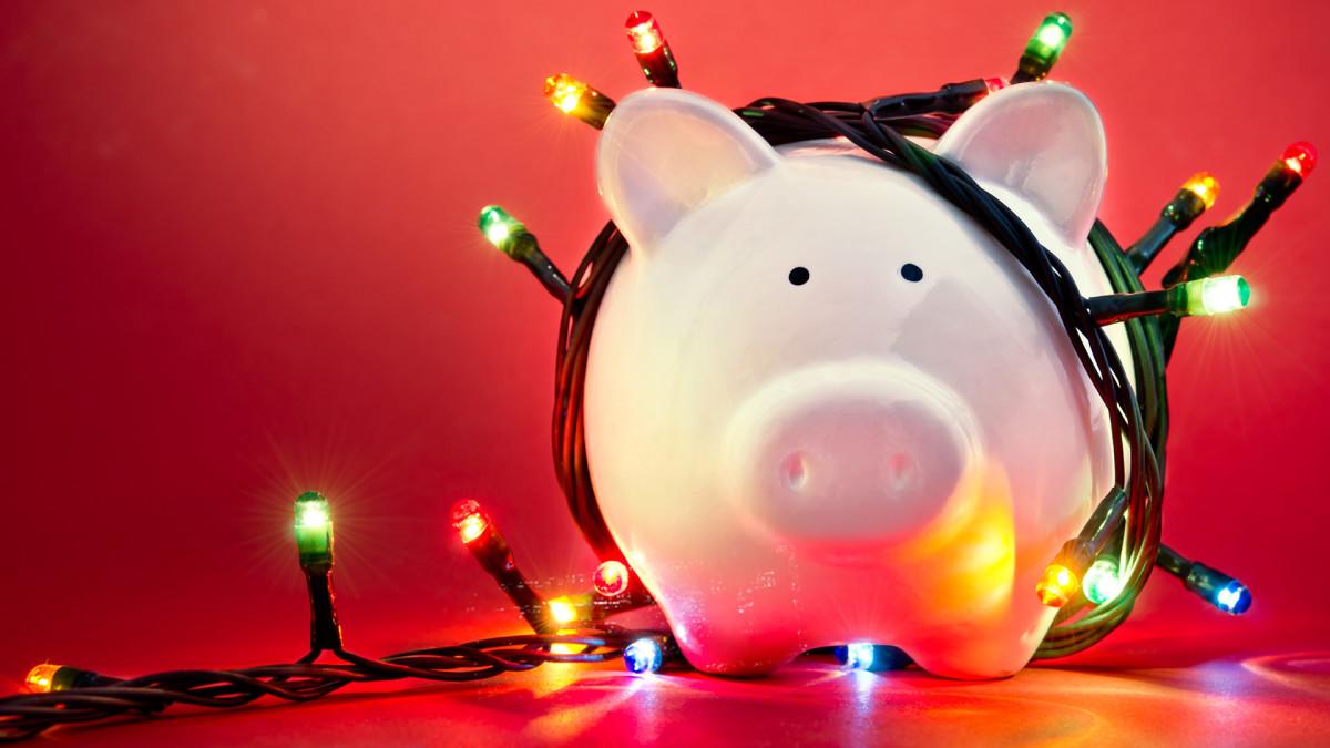 A piggy bank surrounded by multicolored holiday lights.