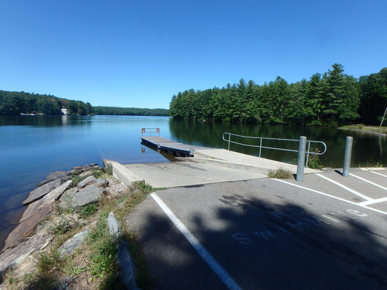 single lane concrete boat ramp with dock, concrete lips on either side