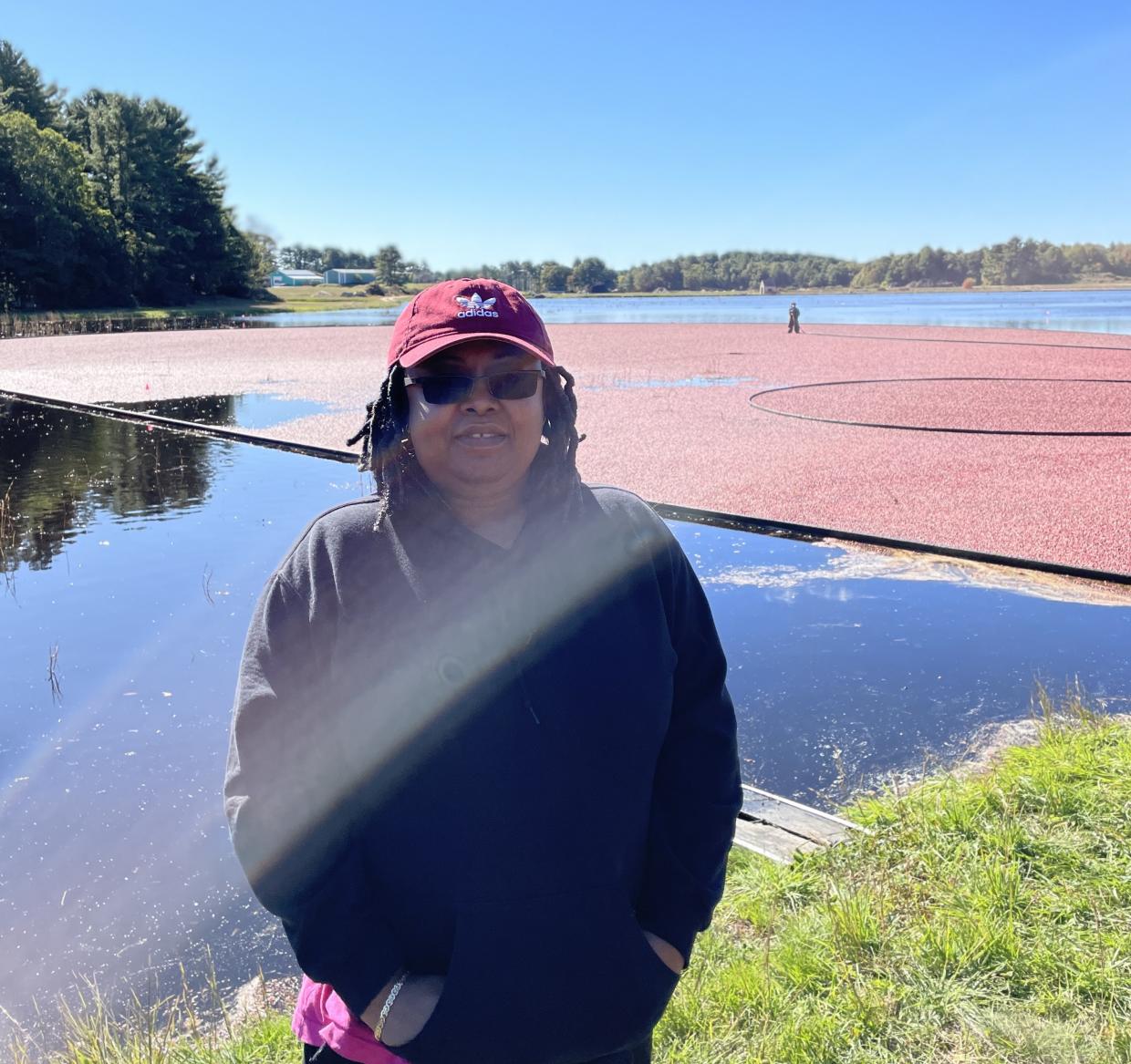 Lindsay Azor standing in front of a cranberry bog.