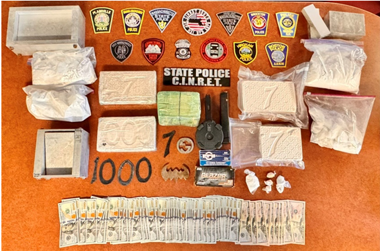 Picture of guns, cash, and drugs recovered from arrest