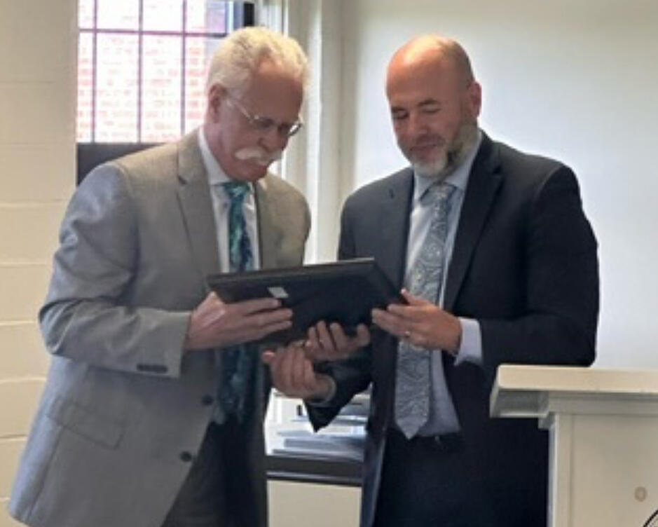 Chief Probation Officer R. Wayne Chase, left, and Deputy Commissioner of Programs Michael Coelho gaze at plaque