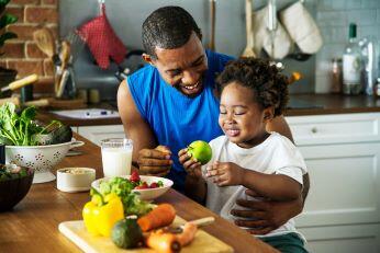 Image of a boy and his father cooking together