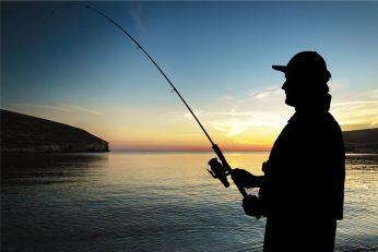 Image of a man fishing at sunset