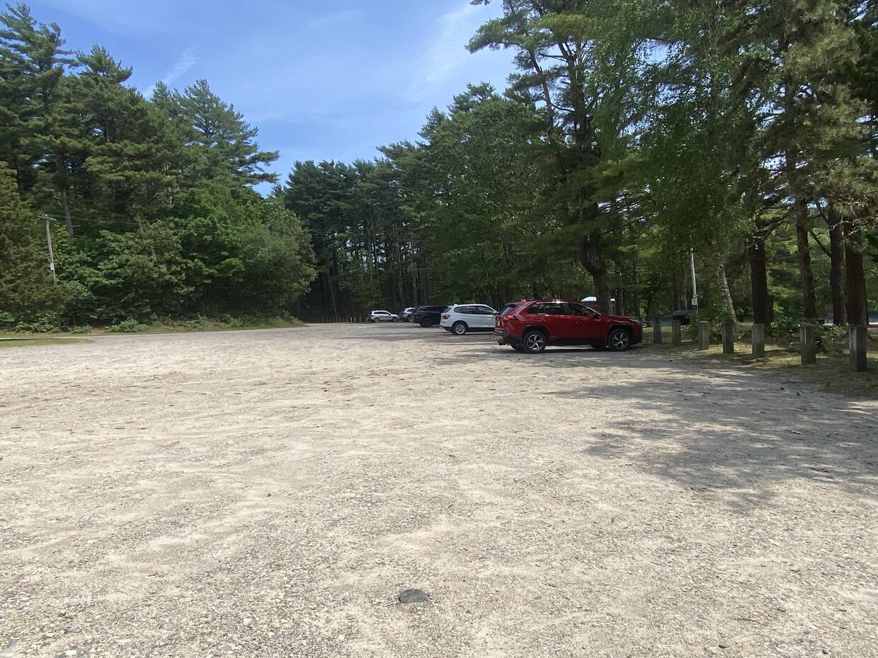 Parking on north side of little pond large gravel lot with a few cars