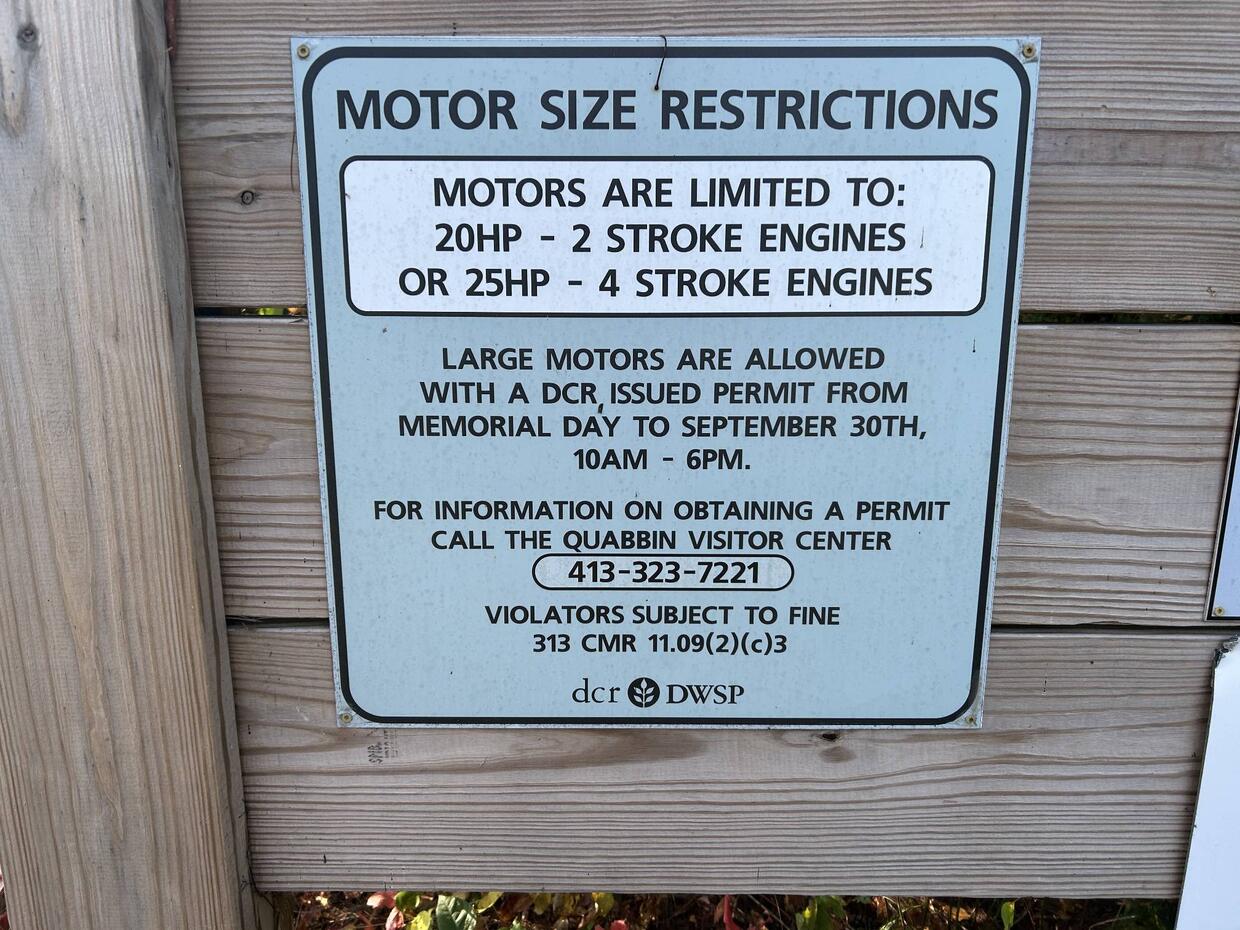 A sign outlining the rules for motor size restrictions. Call 413-323-7221 for permit information.