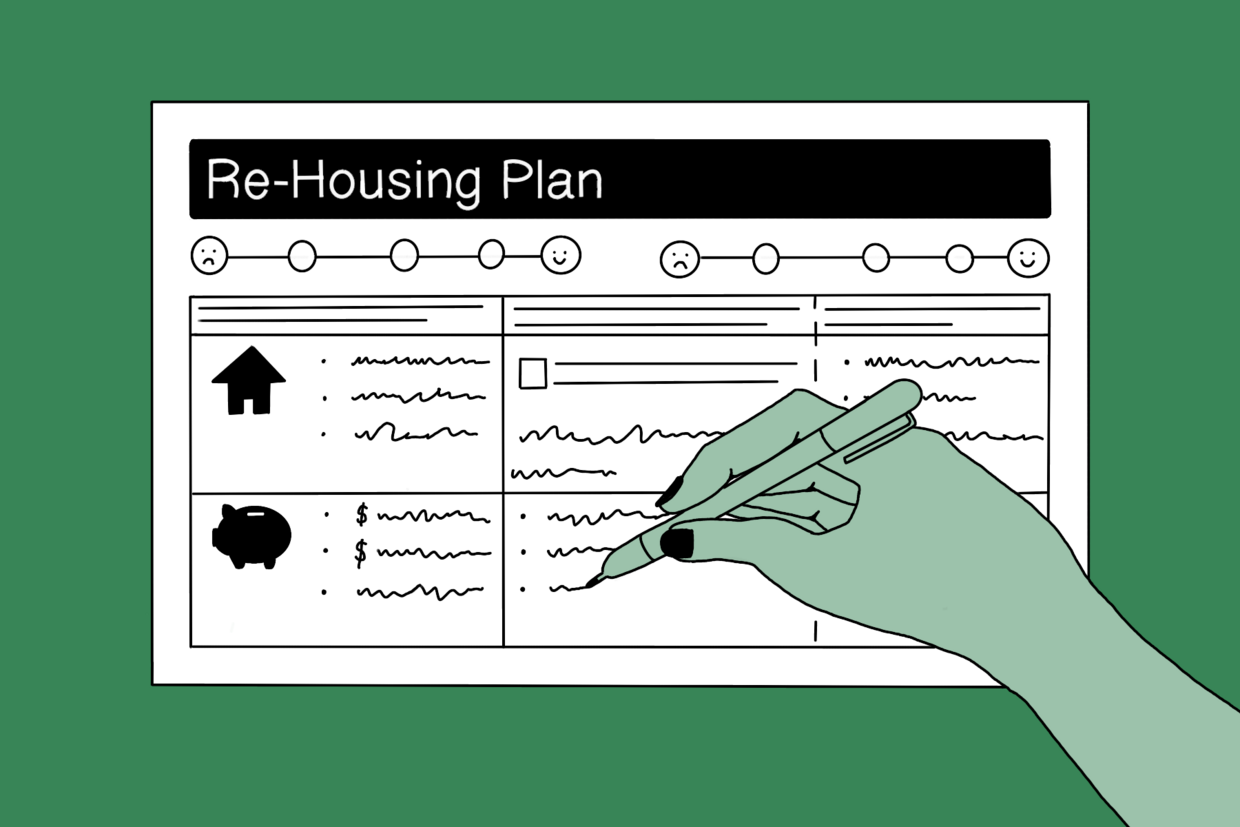 a hand holding a pen, filling out the re-housing plan