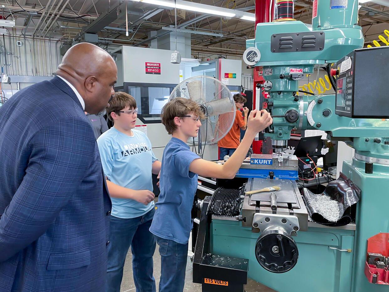 Education Secretary Patrick Tutwiler visits with McCann Technical High School students and helps celebrate the school’s new HVAC lab.