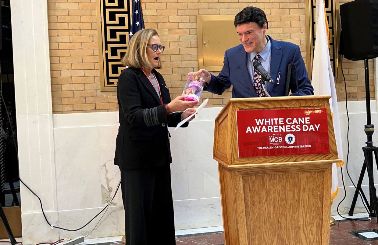 John Oliveira hands Kate Walsh a blind Barbie