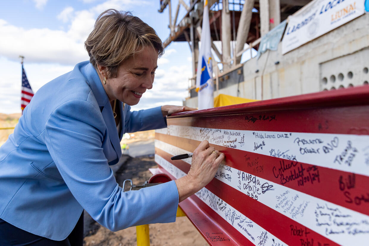 Governor Healey signs beam at Holyoke Soldiers Home Topping Off Ceremony.