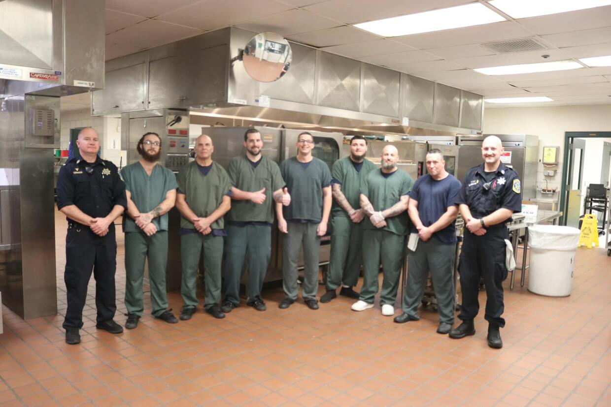 Incarcerated individuals help prepare Thanksgiving meals for individuals in need.