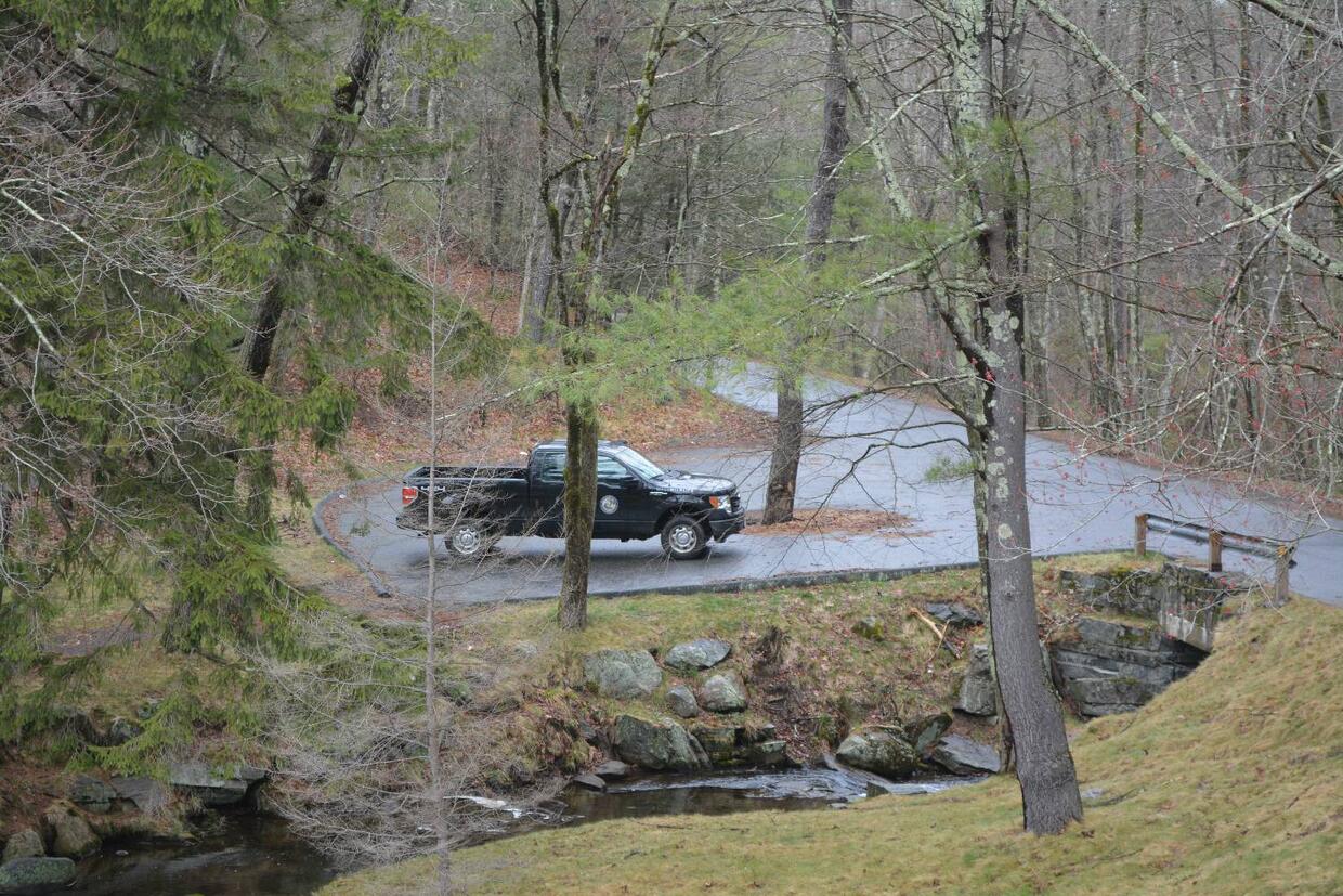 A small, paved parking area by the stream