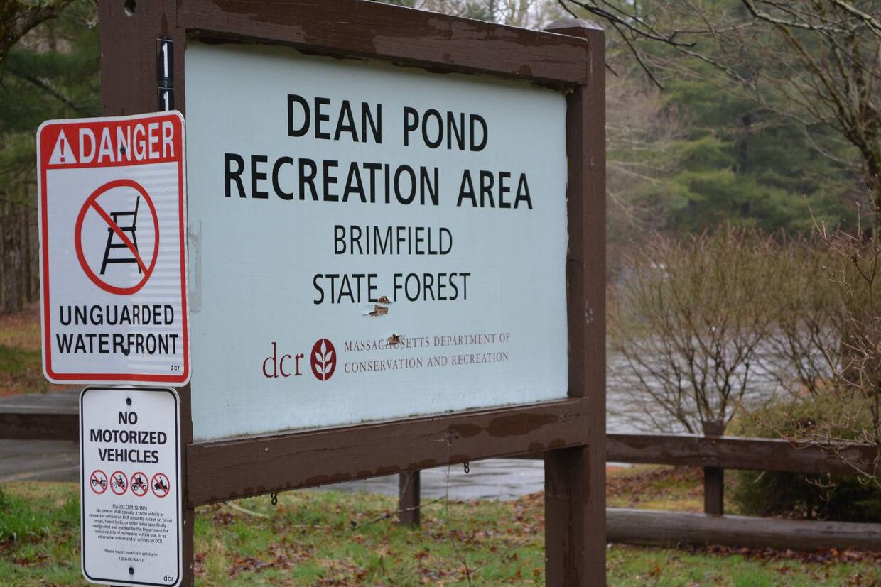 Signs for Dean Pond Recreation Area, warning the waterfront is unguarded, and prohibiting motorized vehicles