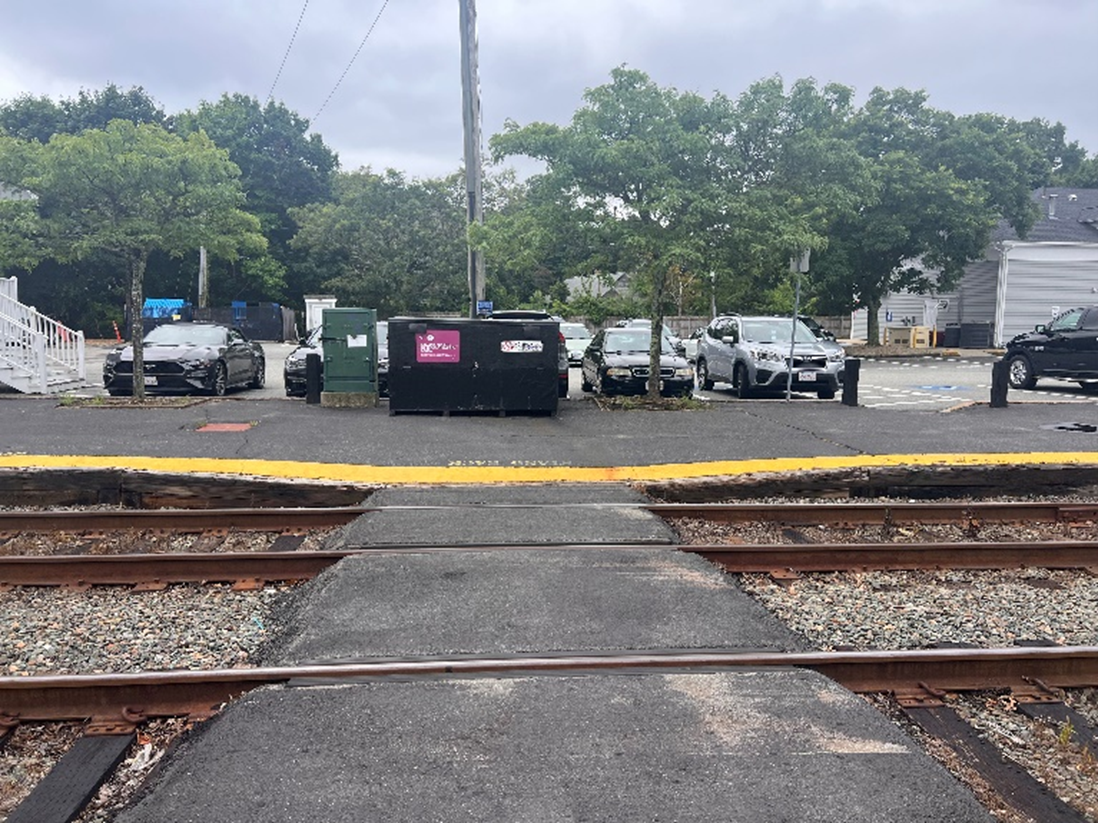 This image shows the far side of a train crossing with no crossing sign at Manchester station.