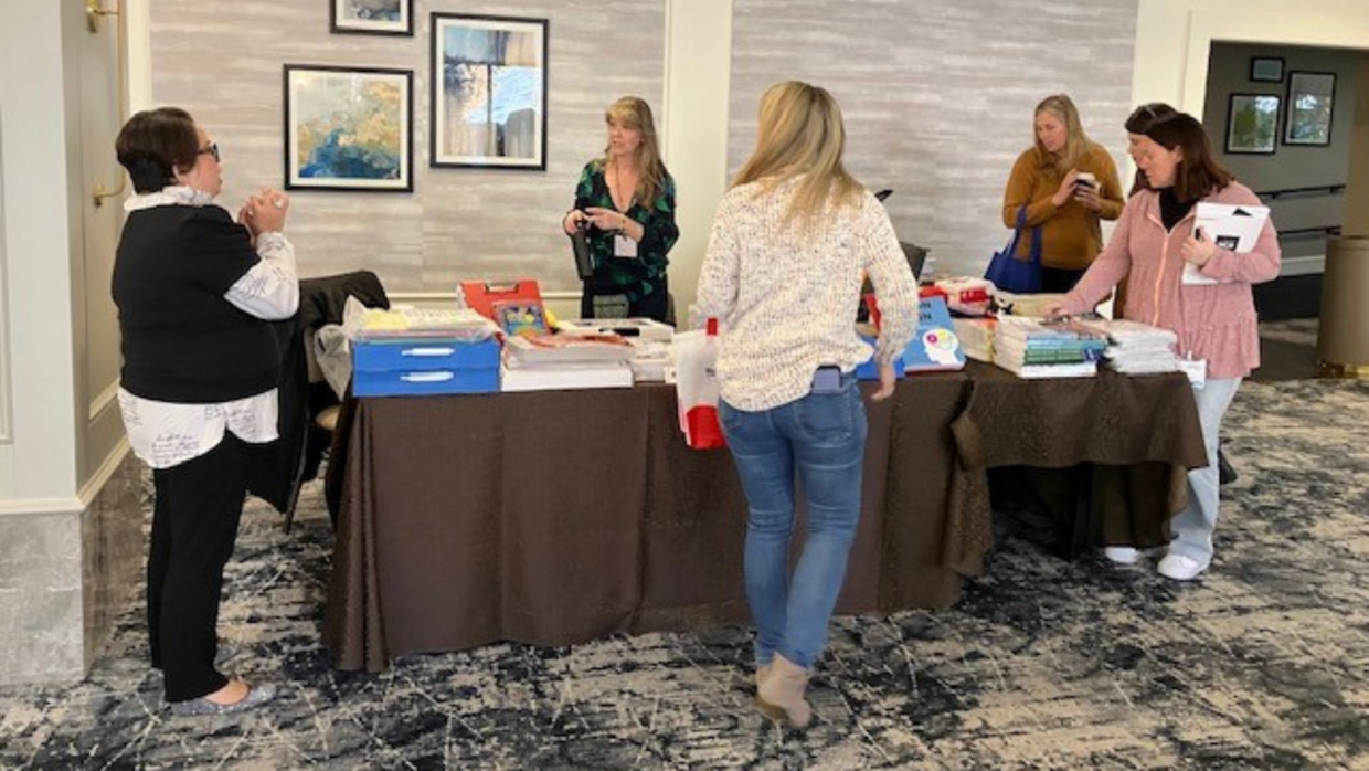 Attendees visiting the AIM Library exhibitor table