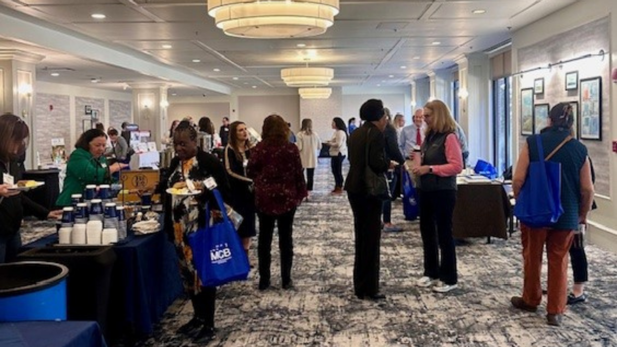 People gathered in the conference hall exhibitor area