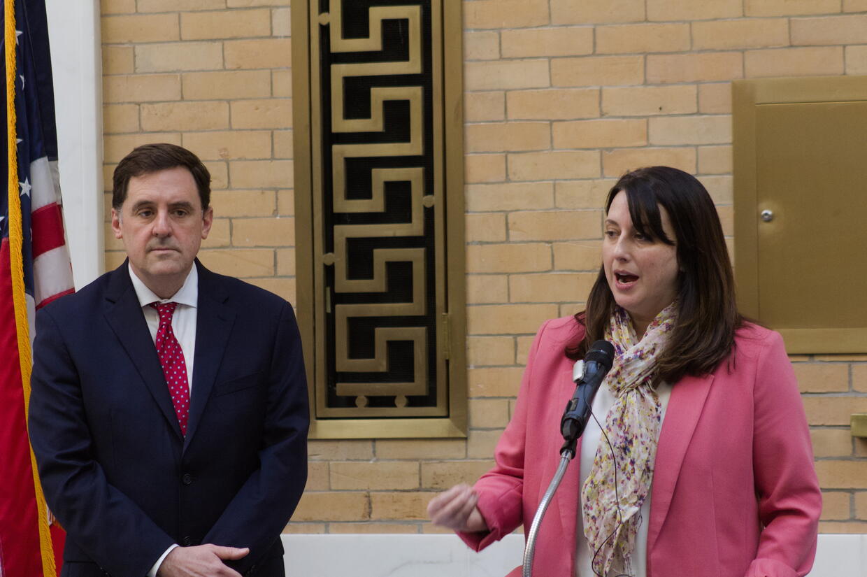 Rep. Jay Livingstone and Sen. Robyn Kennedy speaking from behind the podium