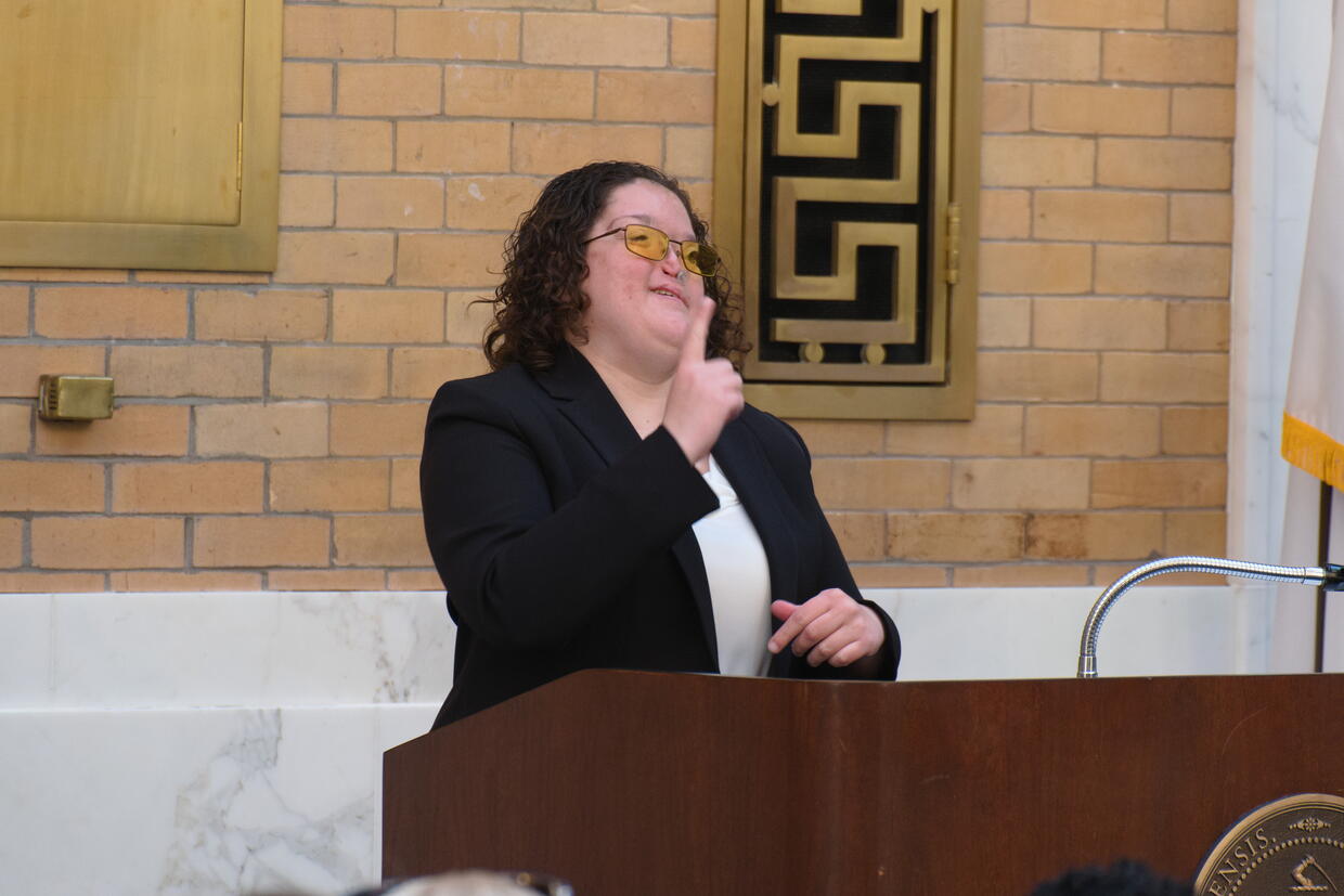 Lacey Clericuzio speaking from behind thee podium