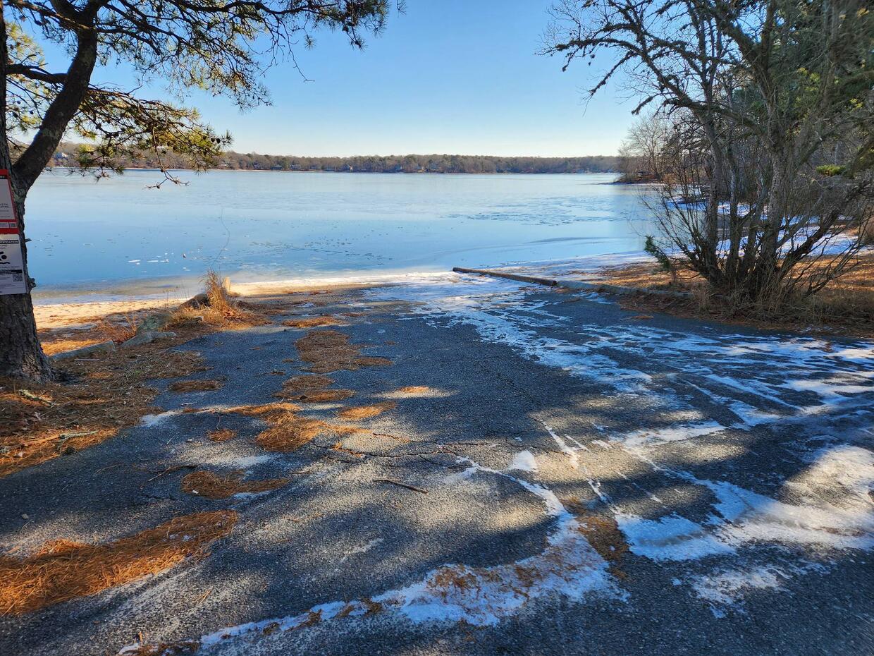 A wide concrete boat ramp leading down to calm water