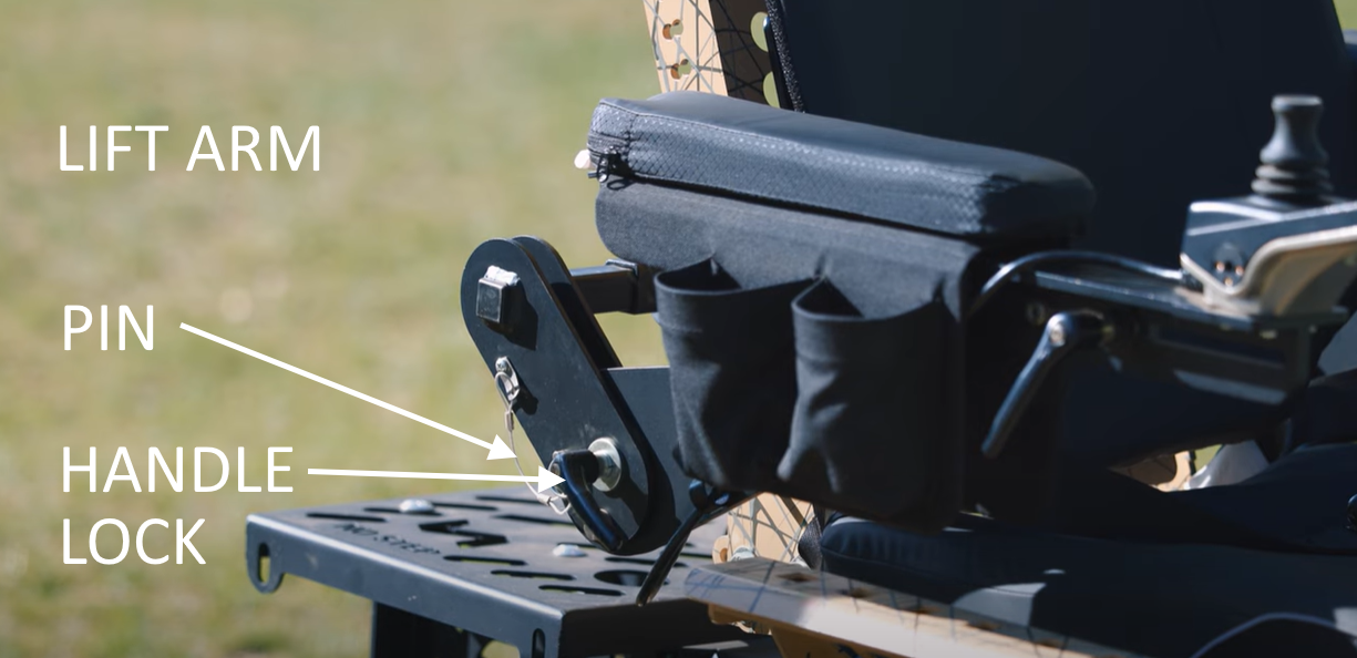 Trackchair arm showing pin and lever to raise arm.