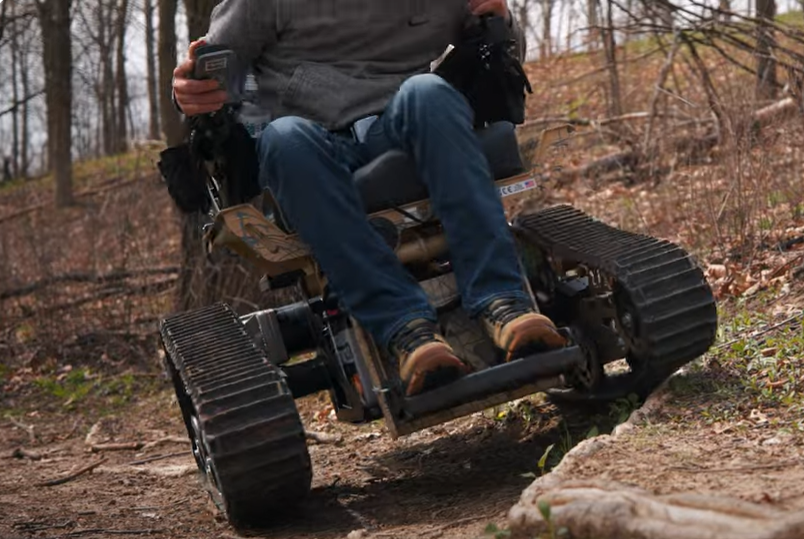 The Trackchair goes over a root on a single track.